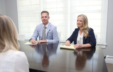 ben and amy of stechschulte nell attorneys at law consulting with a client