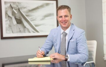 tampa attorney ben stechschulte sitting at a desk looking into the camera smiling